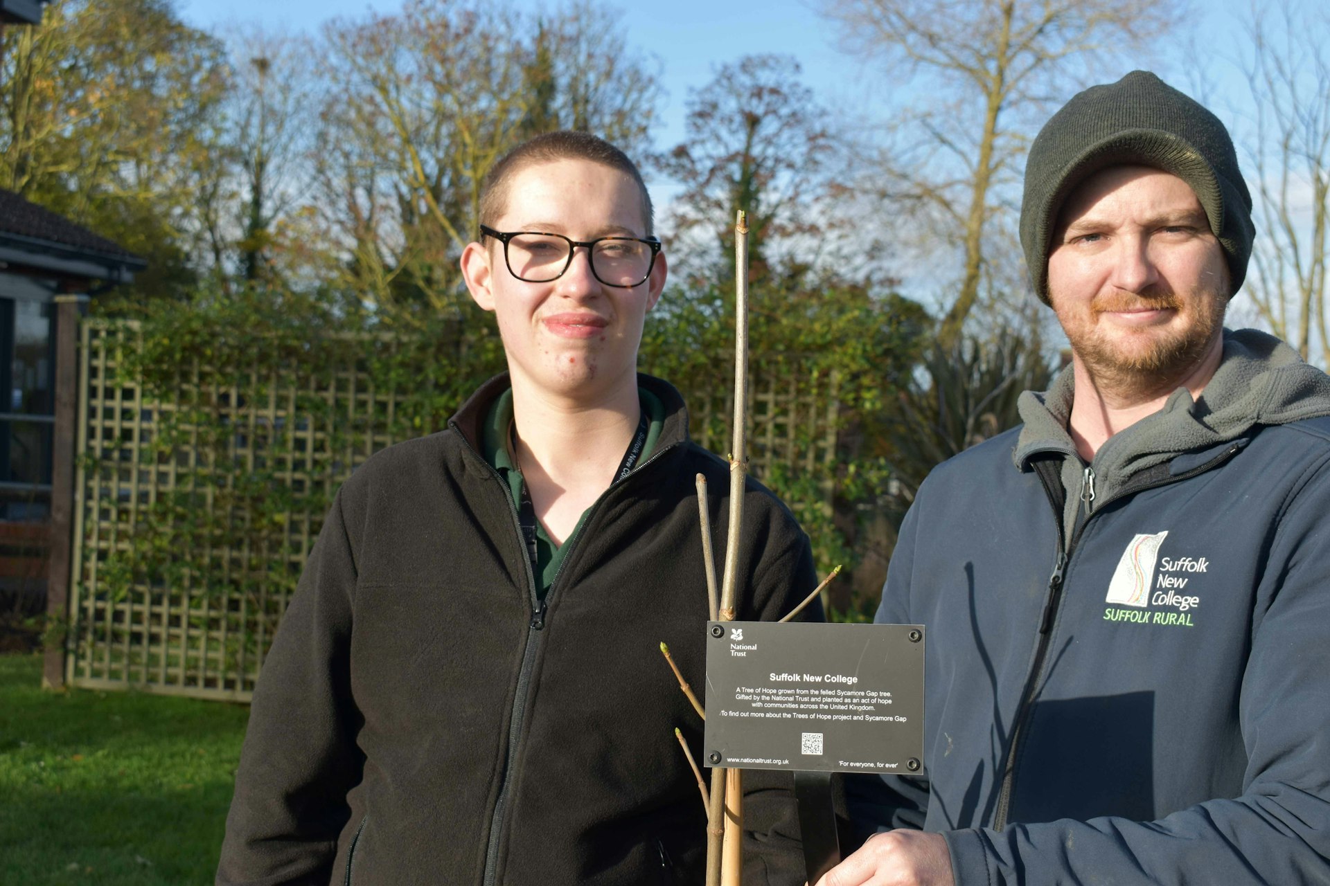 Freddie Martin and Tom Brown by the tree of hope after the planting ceremony